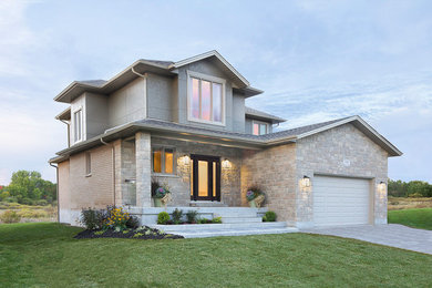 Inspiration for a large transitional beige two-story concrete fiberboard exterior home remodel in Toronto with a hip roof