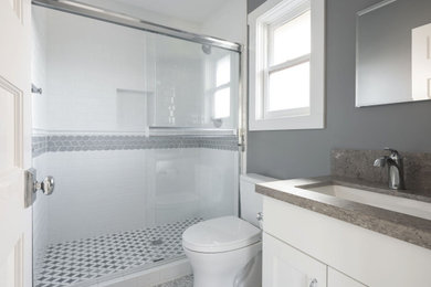 Example of a mid-sized classic white tile and ceramic tile mosaic tile floor and single-sink sliding shower door design in Los Angeles with gray walls, an undermount sink, quartzite countertops and gray countertops