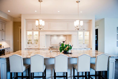Large transitional single-wall dark wood floor eat-in kitchen photo in Edmonton with a drop-in sink, open cabinets, white cabinets, marble countertops, white backsplash, stainless steel appliances and an island