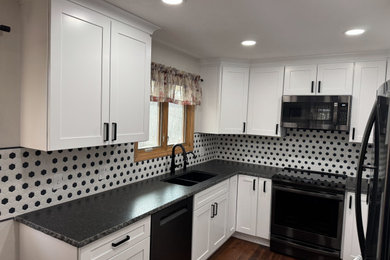 Inspiration for a small transitional u-shaped enclosed kitchen remodel in Other with shaker cabinets, white cabinets, granite countertops and black countertops