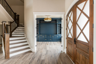 Inspiration for a mid-sized transitional vinyl floor and brown floor entryway remodel in Salt Lake City with beige walls and a medium wood front door