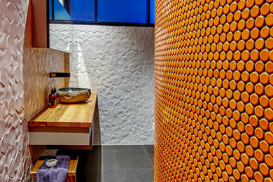 Photo of a small modern bathroom in Wollongong with furniture-like cabinets, an open shower, orange tile, porcelain floors and wood benchtops.