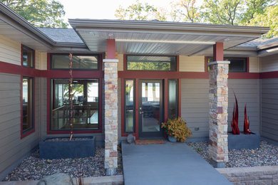 Large transitional concrete floor entryway photo in Other with gray walls and a glass front door