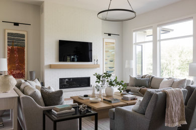 Inspiration for a large transitional open concept light wood floor living room remodel in Other with white walls, a standard fireplace, a brick fireplace and a wall-mounted tv