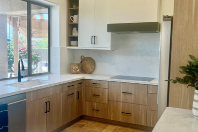 Small transitional u-shaped travertine floor, beige floor and vaulted ceiling eat-in kitchen photo in Phoenix with a drop-in sink, flat-panel cabinets, medium tone wood cabinets, quartz countertops, white backsplash, quartz backsplash, stainless steel appliances, an island and white countertops