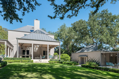 Large contemporary gray two-story stucco exterior home idea in Austin