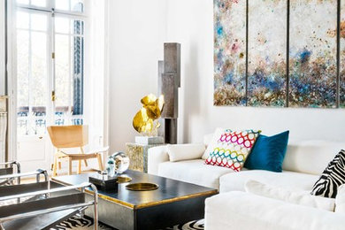 Inspiration for an eclectic open concept living room in Madrid with white walls and medium hardwood floors.