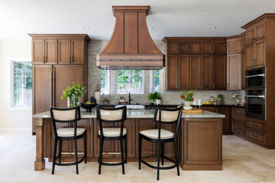 Example of a transitional kitchen design in San Francisco with an island