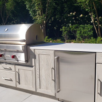 A GRAND SLAM OUTDOOR KITCHEN BY THE TENNIS COURT IN EAST HAMPTON, NY