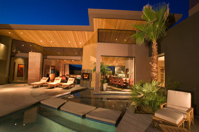 Pool fountain - large contemporary courtyard concrete and custom-shaped lap pool fountain idea in Los Angeles