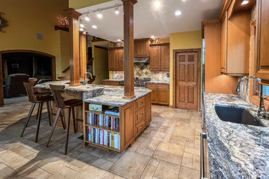 Eat-in kitchen - mid-sized traditional galley eat-in kitchen idea in Cleveland with an undermount sink, shaker cabinets, stainless steel cabinets, quartzite countertops, multicolored backsplash, ceramic backsplash, stainless steel appliances, an island and multicolored countertops