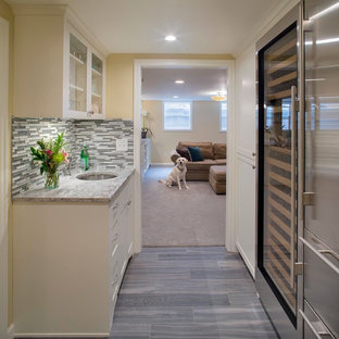 Small classic fully buried basement in Portland with yellow walls and porcelain flooring.