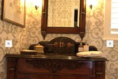 Example of a small transitional powder room design in Houston with furniture-like cabinets, dark wood cabinets and marble countertops