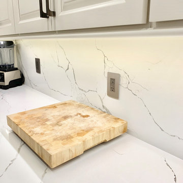 Ivory White Kitchen With Marble Look Quartz Counters and Splash