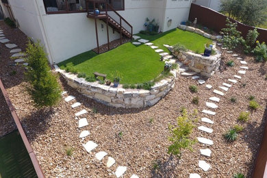 Design ideas for a mid-sized traditional full sun hillside stone retaining wall landscape in Other.