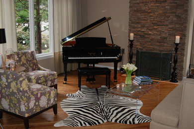 Mid-sized eclectic enclosed medium tone wood floor living room photo in Portland with a music area, beige walls, a standard fireplace, a stone fireplace and no tv