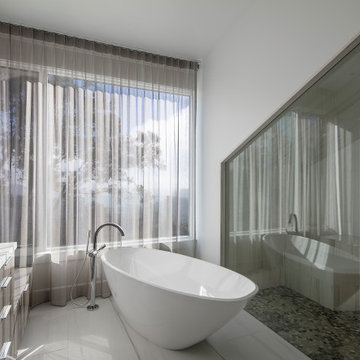 Primary Bathroom with Freestanding Tub and Glazed Shower Wall