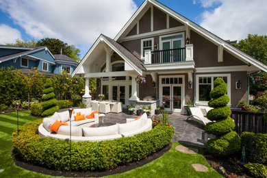 Large minimalist brown three-story stucco house exterior photo in Vancouver with a shingle roof