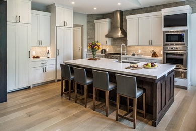 Transitional light wood floor kitchen photo in Other with an undermount sink, shaker cabinets, white cabinets, quartz countertops, stainless steel appliances, an island and white countertops