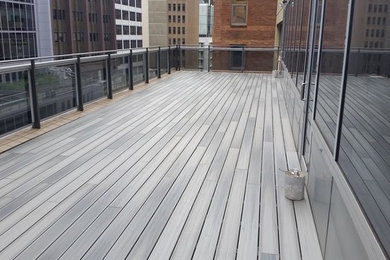 This is an example of a large modern rooftop deck in Sydney with no cover.
