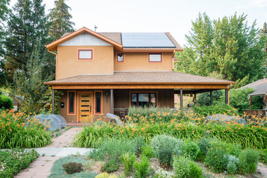 Inspiration for a transitional two-story stucco exterior home remodel in Denver