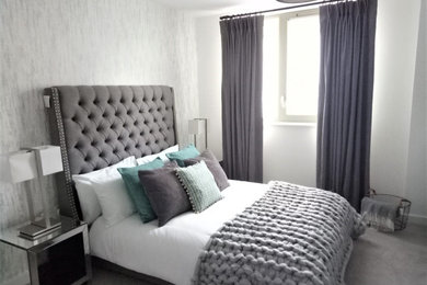 Design ideas for a medium sized urban master bedroom in London with white walls, carpet, no fireplace, grey floors, wallpapered walls and a feature wall.