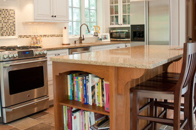 Eat-in kitchen - mid-sized traditional u-shaped porcelain tile eat-in kitchen idea in New York with a drop-in sink, raised-panel cabinets, an island, multicolored backsplash, ceramic backsplash, quartz countertops, white cabinets and stainless steel appliances