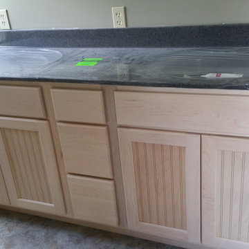 Residential cabinet installation pictures at different stages of completion