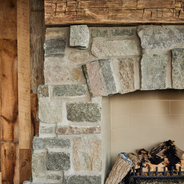 Hand Hewn Timber Mantel Detail on Rustic Farmhouse Stone Fireplace