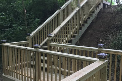 Large side yard deck photo in Other