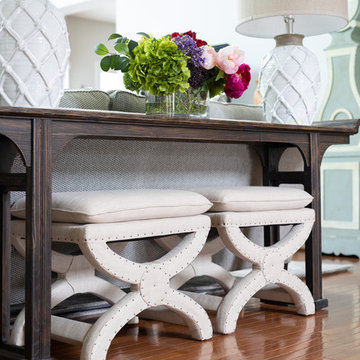 Neutral Two Story Family Room with Tufted Wing Chairs