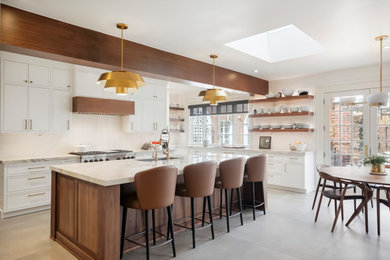 Example of a large transitional u-shaped exposed beam eat-in kitchen design in Denver with an undermount sink, recessed-panel cabinets, white cabinets, white backsplash, paneled appliances, an island and white countertops
