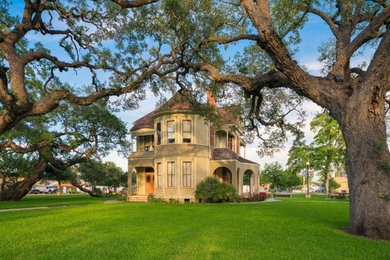 Mid-sized elegant beige two-story mixed siding exterior home photo