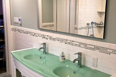 Mid-sized transitional 3/4 blue tile, gray tile, white tile and subway tile gray floor bathroom photo in Chicago with white cabinets, an integrated sink, glass countertops, furniture-like cabinets and white walls