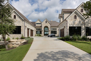 Huge french country white one-story stucco house exterior photo in Austin with a mixed material roof
