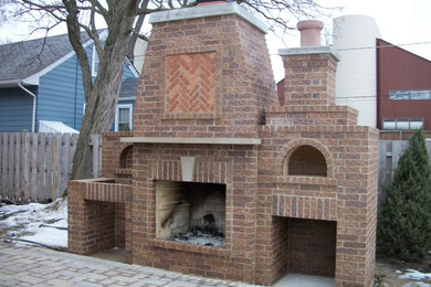 Inspiration for a large timeless backyard brick patio remodel in Chicago with a fire pit and no cover