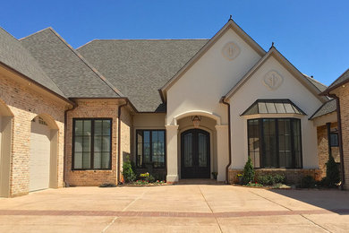 Large tuscan multicolored two-story mixed siding house exterior photo in New Orleans with a hip roof and a shingle roof