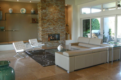 Minimalist open concept travertine floor living room photo in Orange County with beige walls and a stone fireplace