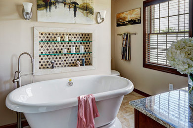 Inspiration for a large mediterranean master beige tile and porcelain tile porcelain tile and beige floor bathroom remodel in Seattle with furniture-like cabinets, medium tone wood cabinets, a two-piece toilet, beige walls, a vessel sink and solid surface countertops
