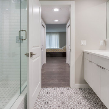 Patterned Tile Bathroom Transitioning to Hardwood Hallway