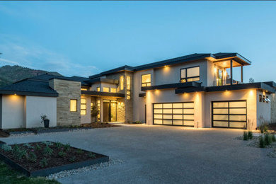 Large contemporary multicolored two-story mixed siding house exterior idea in Albuquerque with a hip roof and a shingle roof