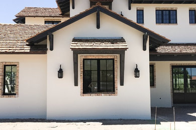 Large transitional white two-story stucco exterior home photo in Phoenix