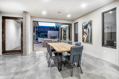Inspiration for a mid-sized modern concrete floor great room remodel in San Diego with white walls