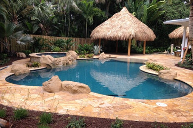 Pool - tropical backyard pool idea in Other
