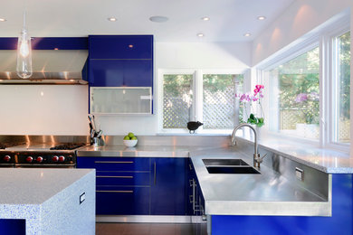 Open concept kitchen - large contemporary l-shaped porcelain tile open concept kitchen idea in Ottawa with an integrated sink, flat-panel cabinets, blue cabinets, quartz countertops, white backsplash, stainless steel appliances and an island