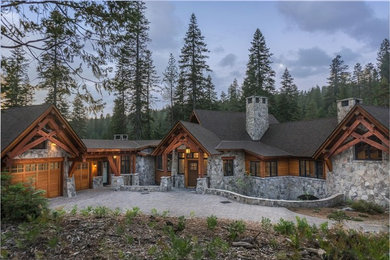 Rustic gray one-story stone exterior home idea in Sacramento with a shingle roof