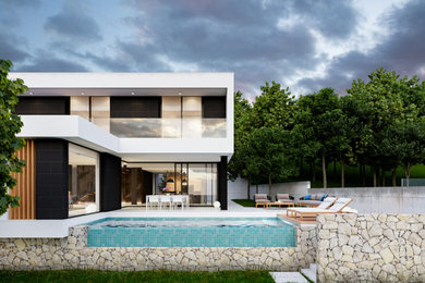 Design ideas for a contemporary three-storey house exterior in Alicante-Costa Blanca with stone veneer and a flat roof.