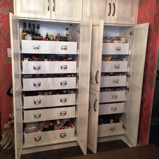 Small transitional kitchen pantry inspiration - Kitchen pantry - small transitional kitchen pantry idea in Montreal with raised-panel cabinets and white cabinets