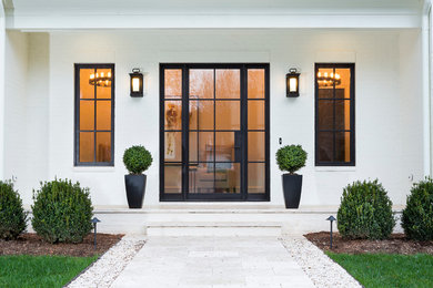 Large minimalist white brick house exterior photo in Charlotte
