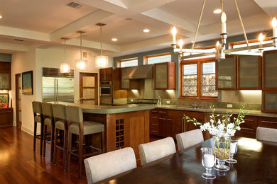 This is an example of a contemporary kitchen in Los Angeles with glass-front cabinets and stainless steel appliances.